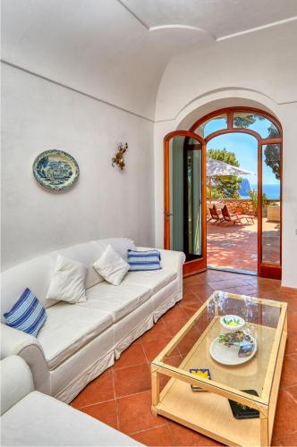 a living room with a white couch and a table at Suite Casa Mia in Capri