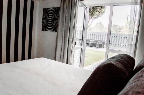 a room with a table and a large window at Seaside Apartments Roja in Roja