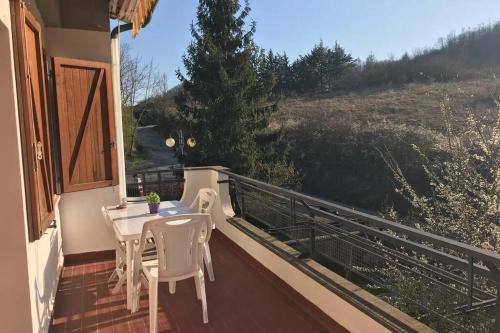 a balcony with a table and chairs and a view at La casa di Chicca in Abbadia San Salvatore