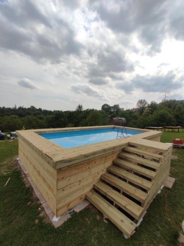 a wooden retaining wall around a swimming pool at Agriturismo La Soglia Del Parco in Ranica