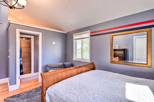 a bedroom with a bed and a mirror at Coastal Abode with Beach Views, Walk to Beach and Bars in Middletown