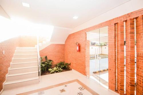 una escalera de ladrillo en una casa con una pared de cristal en N1A2 - New, Nice, for Long and Short Stay, en Asunción