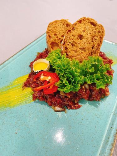 a blue plate of food with a sandwich and bread at Biruza Club in Svyatopetrivske