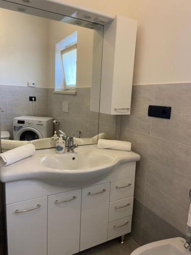 a bathroom with a sink and a mirror at Coronata 22 in Fossano