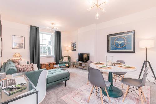 a living room with a couch and a table at Oxfordshire Living - The Spencer Apartment - Woodstock in Woodstock