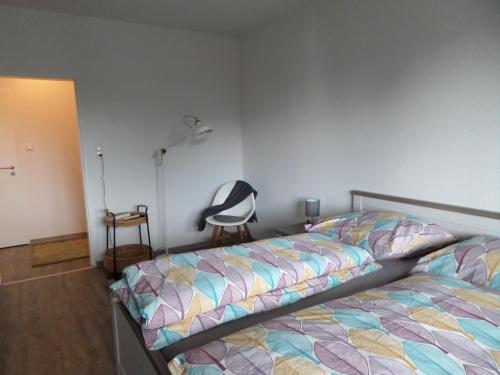 a bedroom with a bed and a chair in it at Apartment Zentrum in Bad Zwischenahn