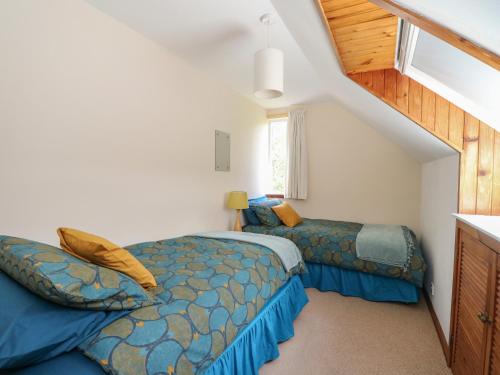 1 dormitorio con 2 camas en un ático en Upper Brackendale, en Taynuilt
