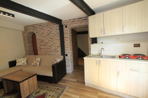 a living room with a couch and a kitchen at Coskun House in Istanbul