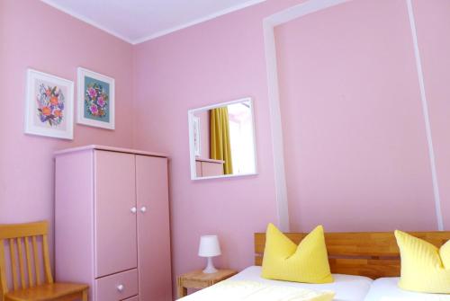 
a bedroom with a white bed and white walls at Pension Stoi budget guesthouse in Innsbruck
