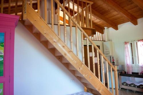 a wooden staircase in a room with wooden ceilings at Agriturismo Prato degli Angeli in Sassoleone