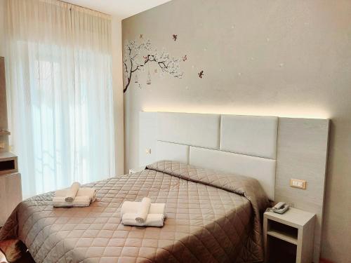 Postel nebo postele na pokoji v ubytování Hotel Monica