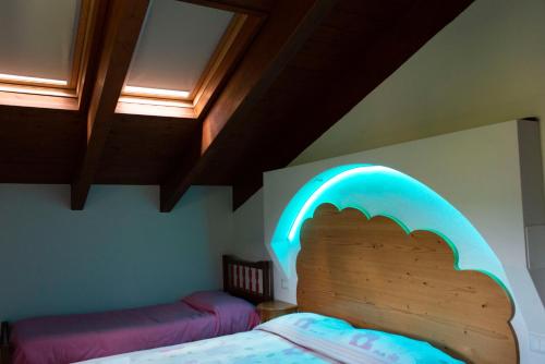 a bedroom with a bed with a lighted headboard at Agriturismo Prato degli Angeli in Sassoleone