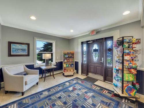a waiting room with a chair and a door at 212 Water Street Inn in Boyne City