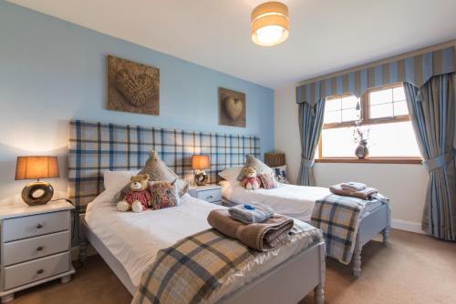 a bed room with two beds and a desk at Valleyview House in Thurso