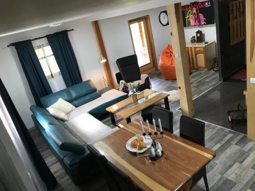 a living room with a couch and a table at Planinski biser Mokra Gora in Mokra Gora