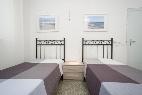 2 letti posti uno accanto all'altro in una camera da letto di Villa La Terrazza sul Mare - Goelba a Fetovaia