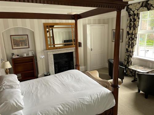 a bedroom with a bed and a fireplace at Arundel House in Whitby