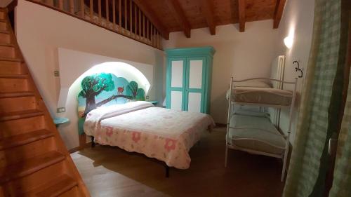 a bedroom with a bed and a chair in a room at Agriturismo Prato degli Angeli in Sassoleone