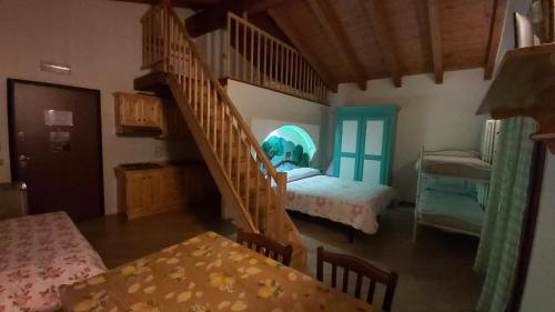 a room with a staircase and a bedroom with a bed at Agriturismo Prato degli Angeli in Sassoleone