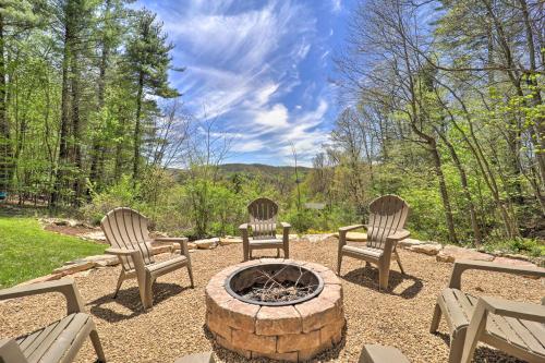 three chairs and a fire pit in a yard at Woodsy Mountain-View Getaway with Hot Tub! in Boone