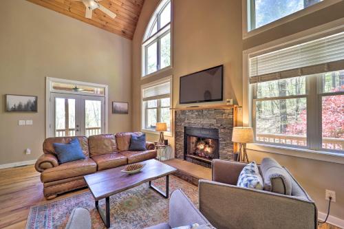 a living room with a couch and a fireplace at Woodsy Mountain-View Getaway with Hot Tub! in Boone