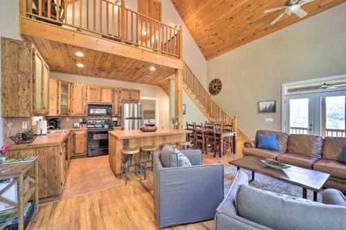 a living room with a couch and a kitchen at Woodsy Mountain-View Getaway with Hot Tub! in Boone