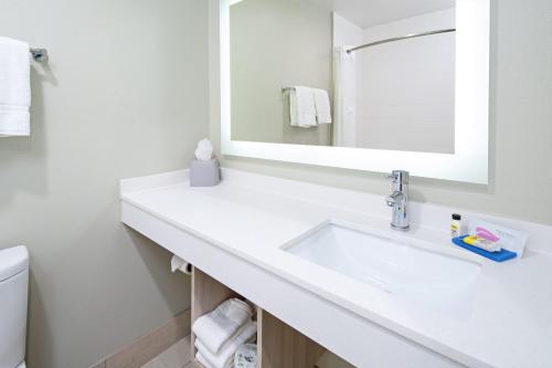 a bathroom with a white sink and a mirror at Holiday Inn Express & Suites Watsonville by IHG in Watsonville