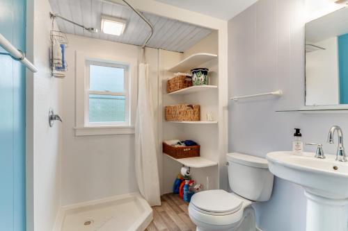 a bathroom with a white toilet and a sink at Dune Grass Cottage in Copalis Beach