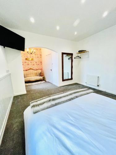 a bedroom with a large white bed in a room at Monopoly Holiday Home in Blackpool