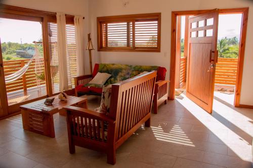 a living room with a couch and a table at Chez Manany Galapagos Ecolodge in Puerto Villamil