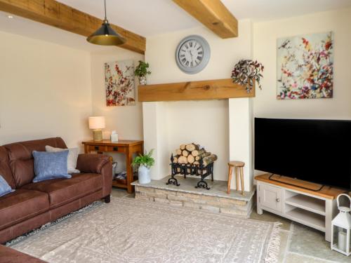 a living room with a couch and a flat screen tv at West Reins in Barnard Castle