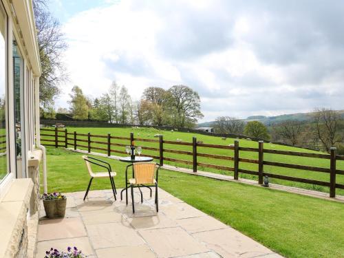a patio with a table and chairs and a fence at West Reins in Barnard Castle