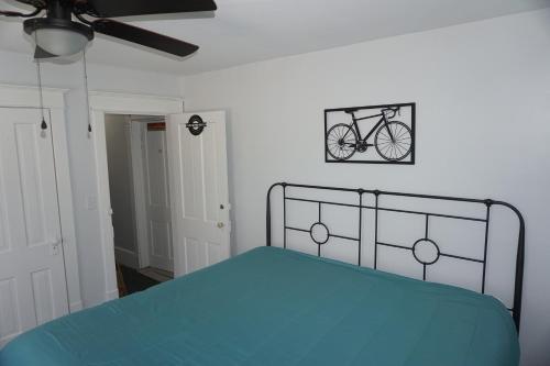a bedroom with a bed with a bike on the wall at Charlevoix House - The Northside in Charlevoix