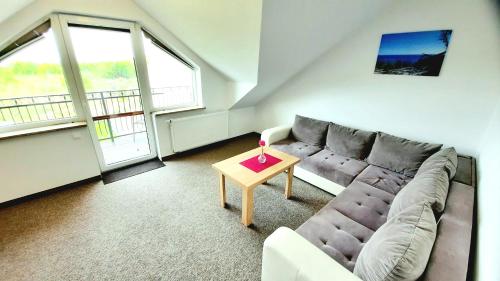 a living room with a couch and a table at Morska Fala in Jastarnia