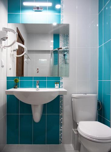 a bathroom with a white toilet and a sink at Hotel Vanilla, Varna - Free parking in Varna City