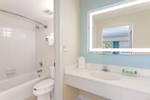 a bathroom with a sink, toilet, and bathtub at Holiday Inn Key Largo, an IHG Hotel in Key Largo