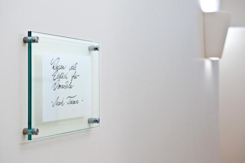 a mirror with a sign that reads your not your best friend will never hurt you at Town Hotel Wiesbaden - kleines Privathotel in Bestlage in Wiesbaden