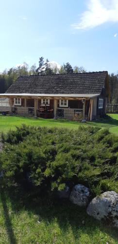 a house with a large yard with rocks in front of it at Sodyba Vieversynė in Duokiškis