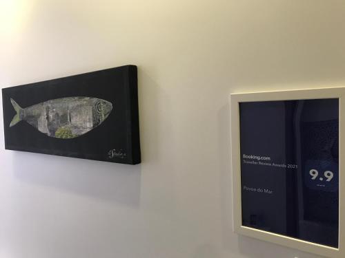 a picture of a fish on a wall next to a picture at Povoa do Mar in Póvoa de Varzim