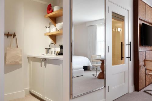 a bathroom with a door leading to a bedroom at Lyle DC in Washington