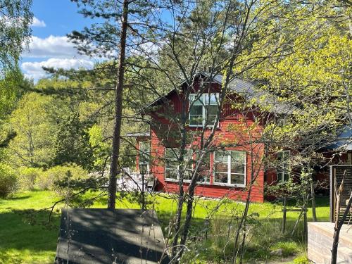 a red brick house in the middle of a yard at Villa Myttinge in Värmdö