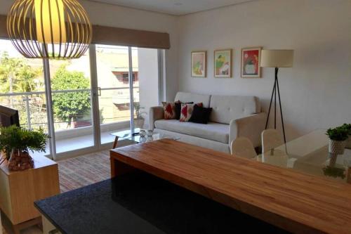 a living room with a couch and a table at N4A1 - New, Nice, for Long and Short Stay in Asuncion