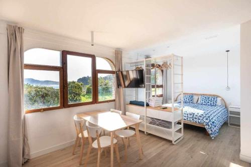 a bedroom with a table and a bed and a desk at LUR Getaria in Getaria