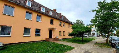 uma grande casa amarela com uma entrada em frente em Apartament Grunwaldzka em Tuchola
