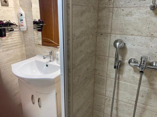 a bathroom with a shower and a sink at Halkoz Apartment in Debrecen