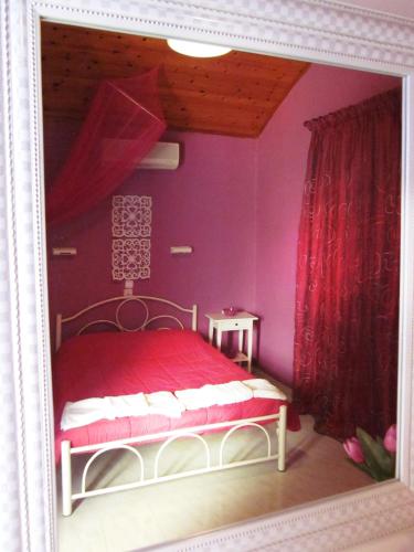 a picture of a bedroom with a bed with purple walls at Palma Sidari Corfu in Sidari