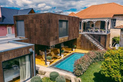 an external view of a house with a swimming pool at Casa das Mourôas in Mondim de Basto