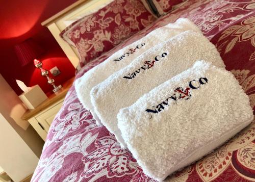 a pair of towels sitting on top of a bed at Navy & Co in Houesville
