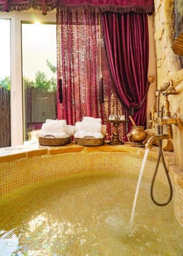 a bathroom with a bath tub with a water fountain at Lethe Exclusive Hotel in Ağva