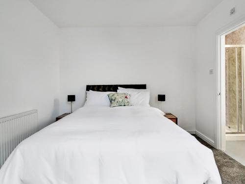 a white bedroom with a large white bed at Albert View Rooms in Manchester